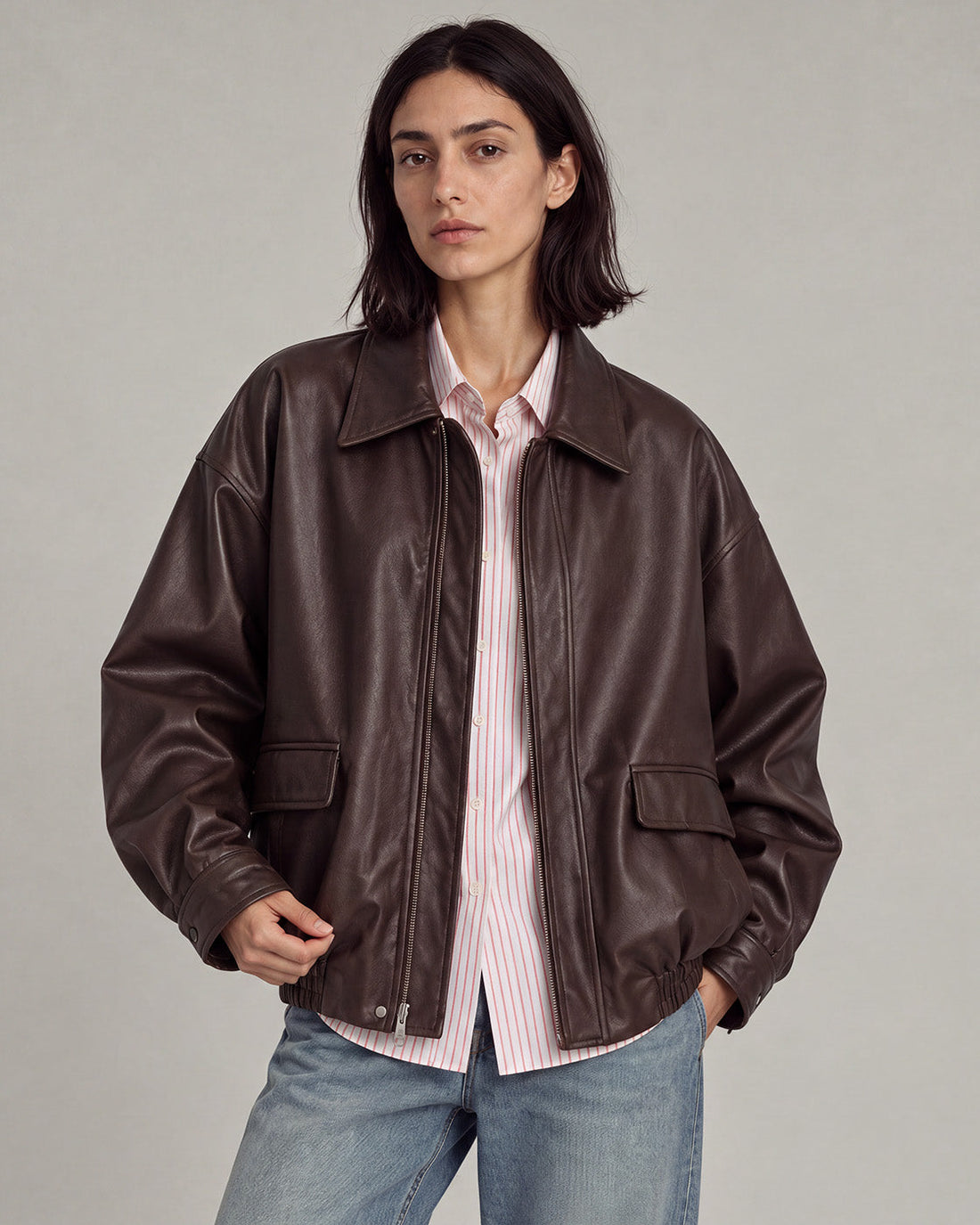 Relaxed brown faux-leather zip jacket with dropped shoulders and gathered hem.