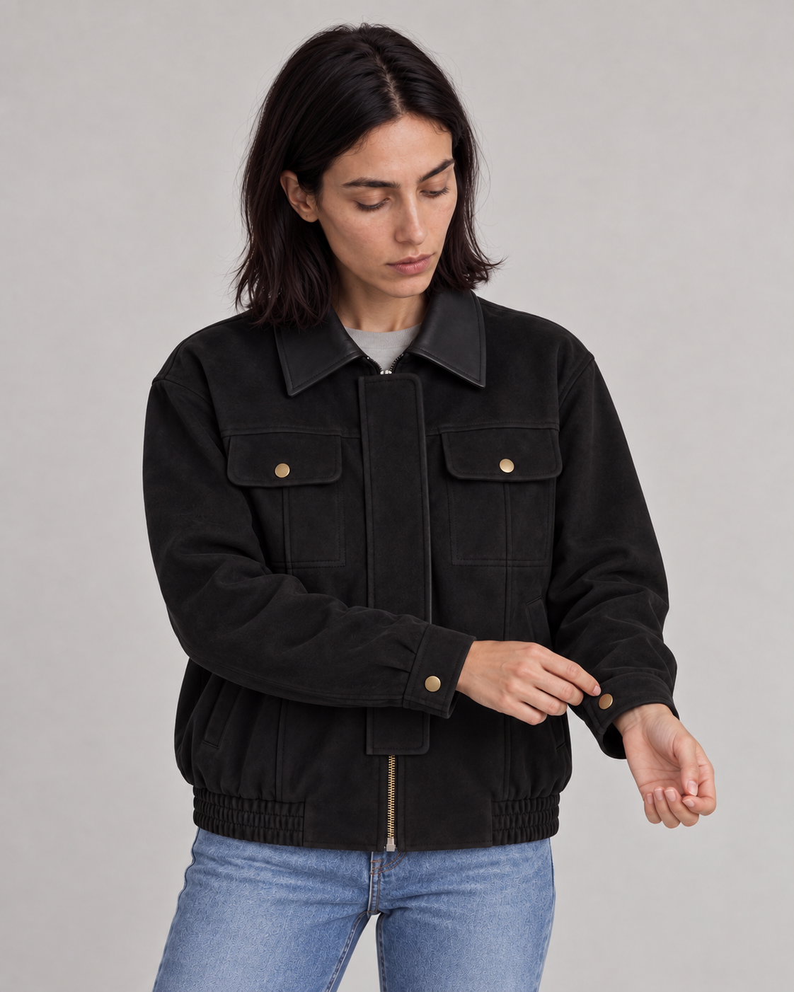 Model wearing the black Contrast-Collar Suede Jacket while adjusting the sleeve cuff