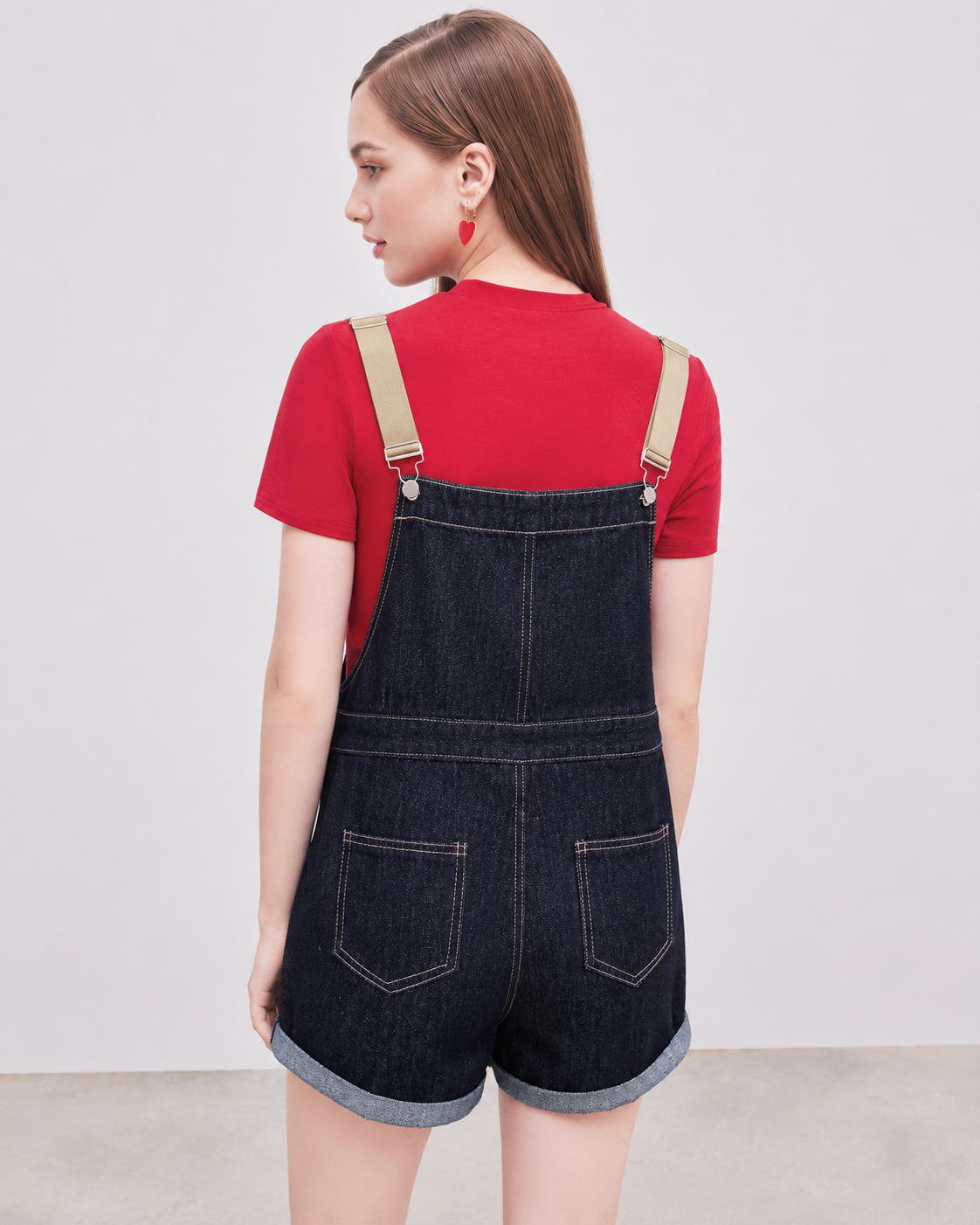 Denim relaxed overall romper on model, full back view