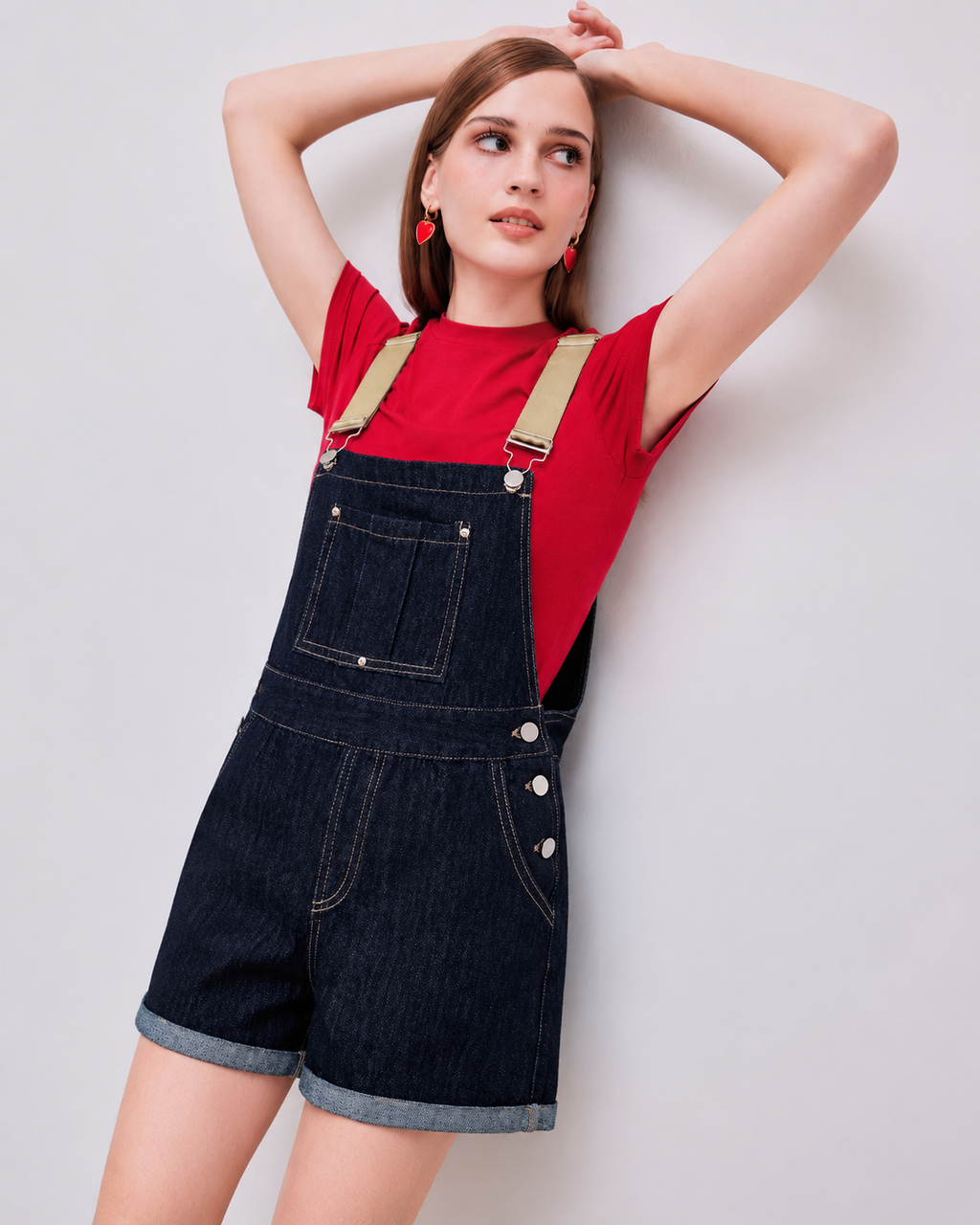 Denim relaxed overall romper on model, standing front pose