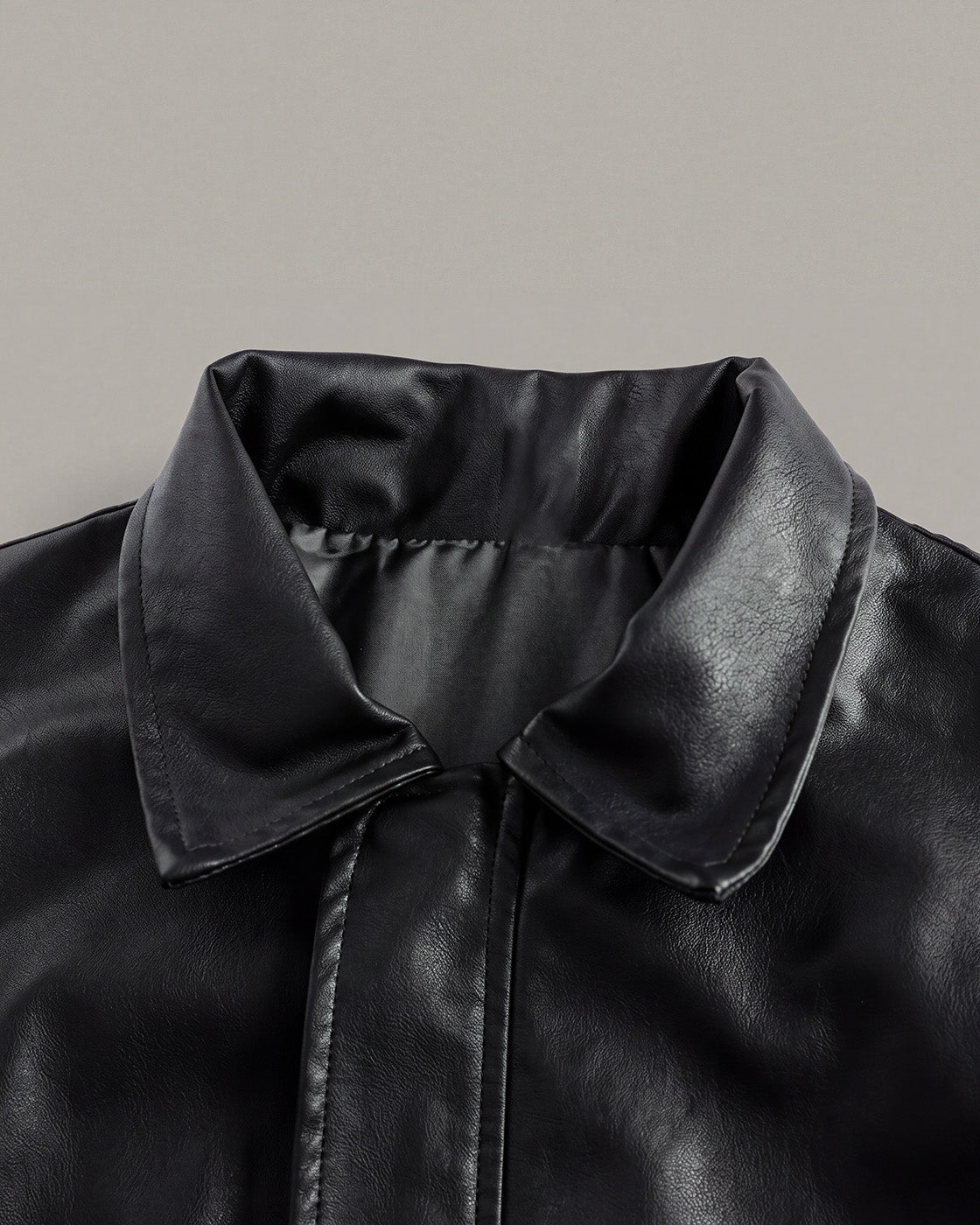 Relaxed Faux-Leather Zip Jacket in Black — detail collar
