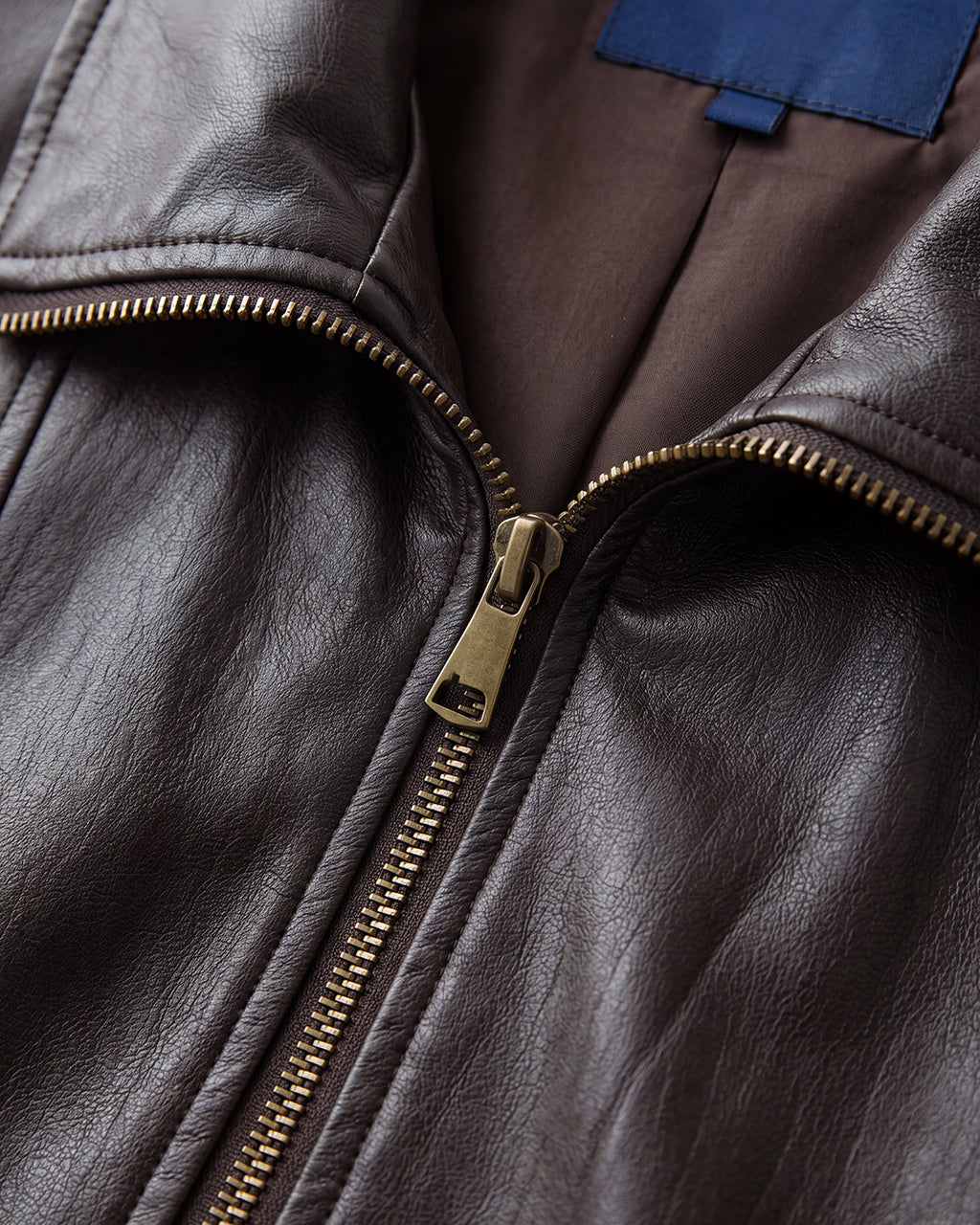 Buckle-Hem Faux-Leather Zip Jacket in Deep Brown — detail one