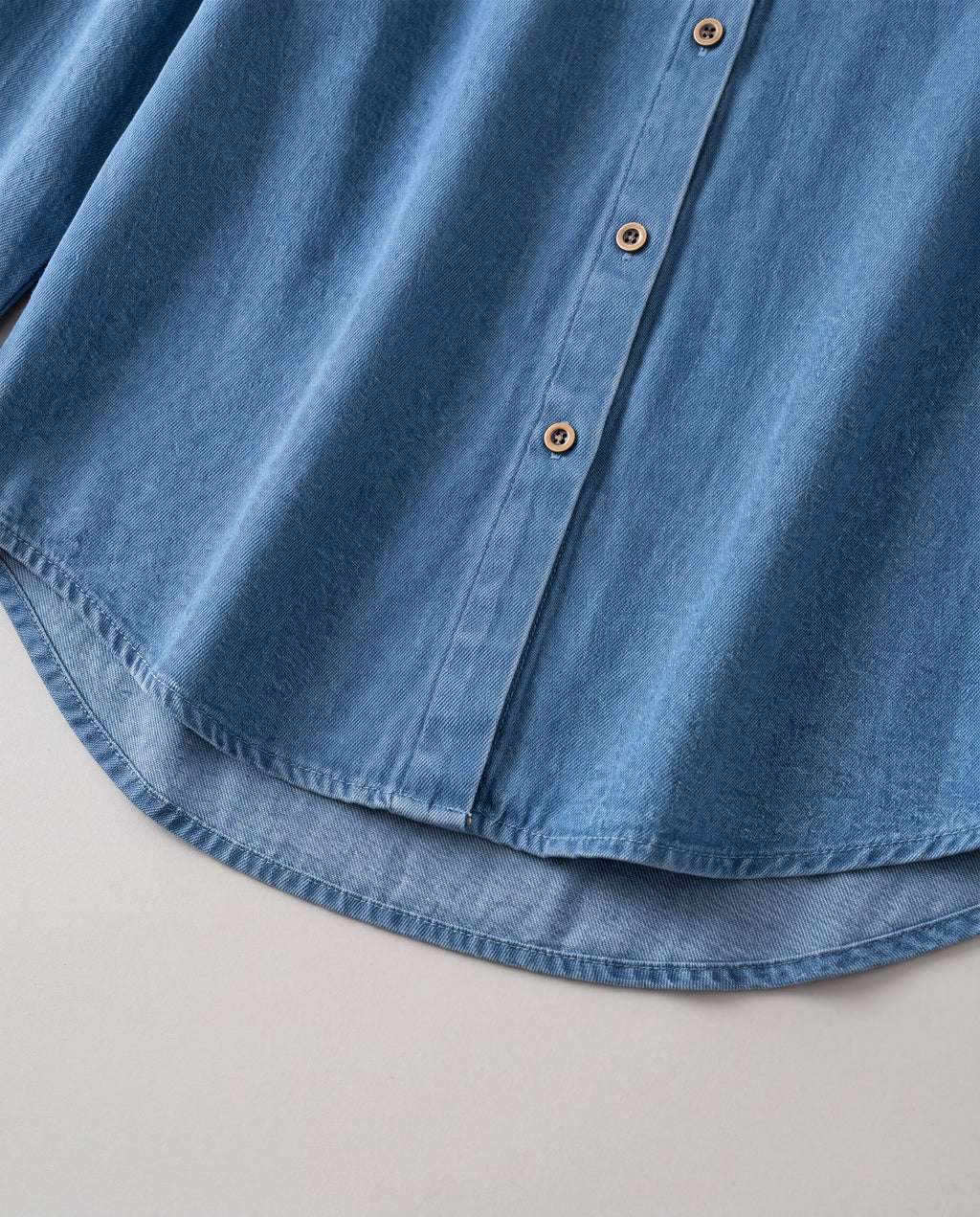 Relaxed Denim Button-Up Shirt — Blue, hem detail