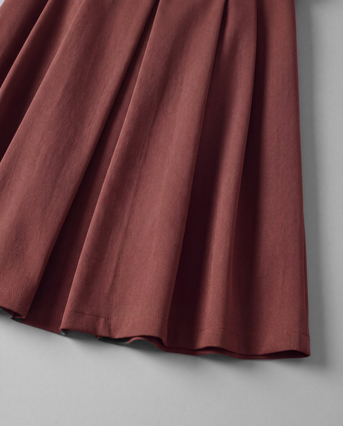 Wool-Look Pleated Midi Skirt — Burgundy, hem detail