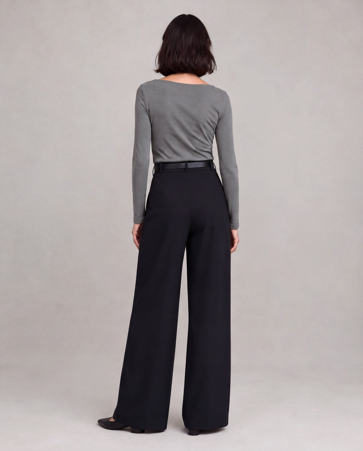 High-Rise Pleated Wide-Leg Trousers — Black, model back view