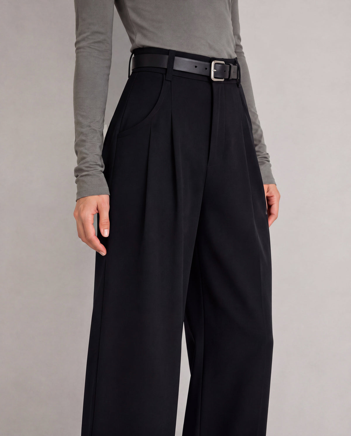 High-Rise Pleated Wide-Leg Trousers — Black, model detail