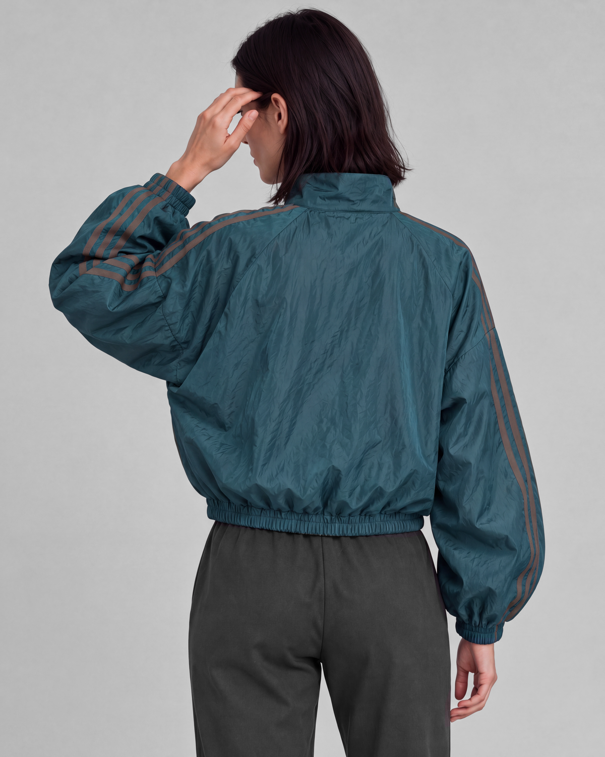 Deep teal jacket, back close view on model