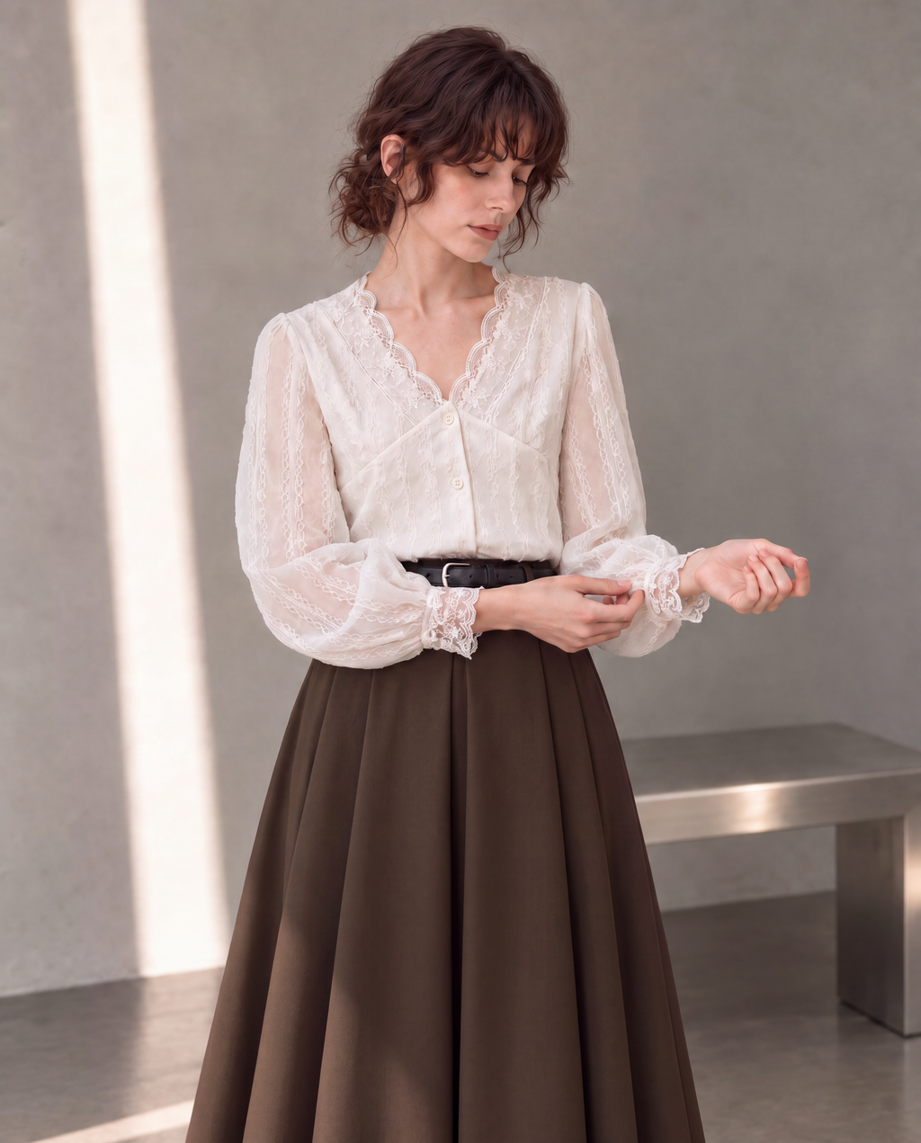Workday Edit Look 01 – White lace-trim V-neck blouse 3244, upper-body cuff interaction with Coffee Brown pleated midi skirt 8252 in the gray wall scene.