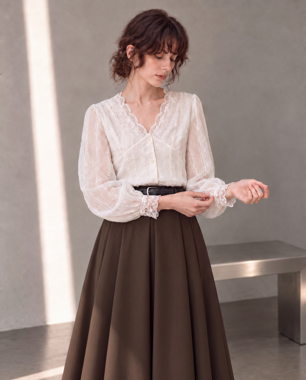 Workday Edit Look 01 – White lace-trim V-neck blouse 3244, upper-body cuff interaction with Coffee Brown pleated midi skirt 8252 in the gray wall scene.